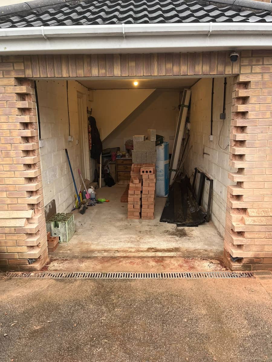 A garage with the door taken out, the brick opening toothed ready to be built in