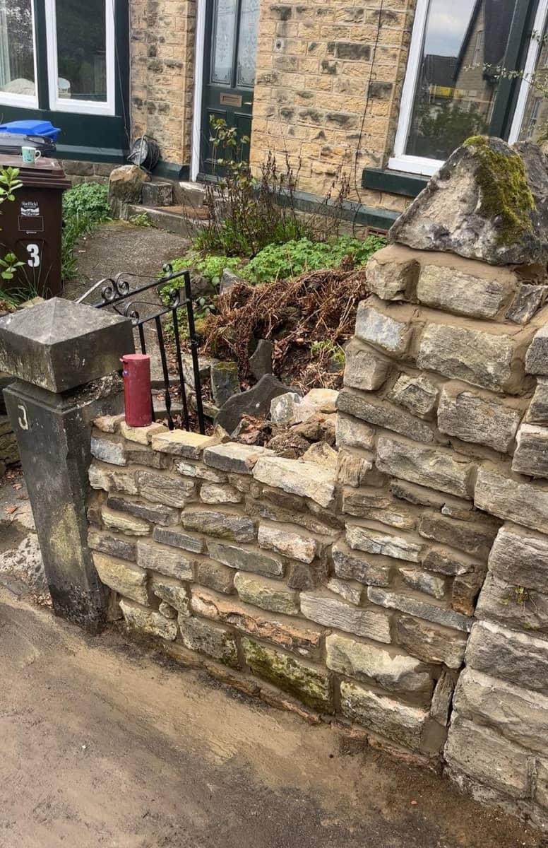 The same corner at number 3 rebuilt in coursed sandstone, running up to the gatepost again